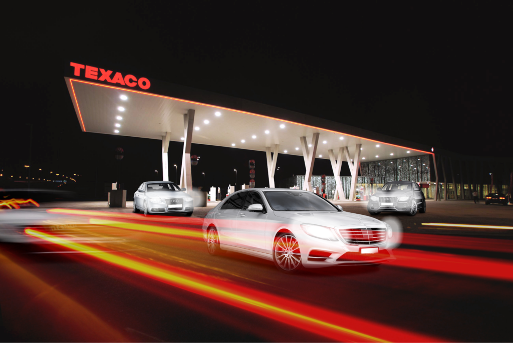 Cars moving along the road in a Texaco petrol station